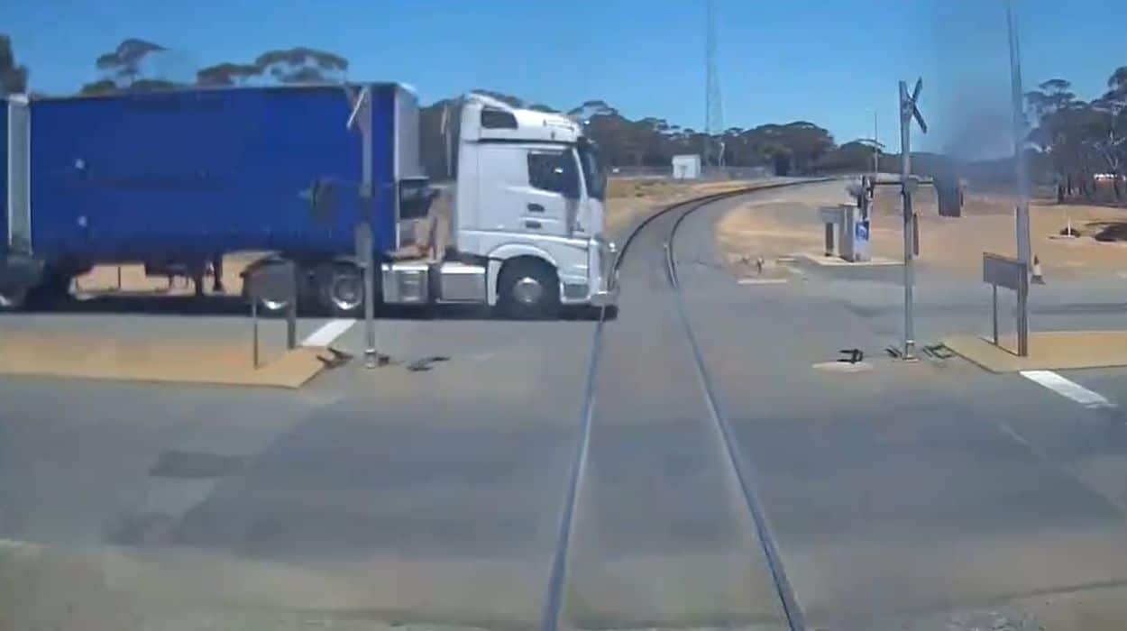 Brutally close call between a B Double truck and a freight train in the Goldfields